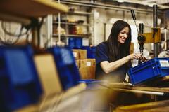 Smiling woman working on a production site.