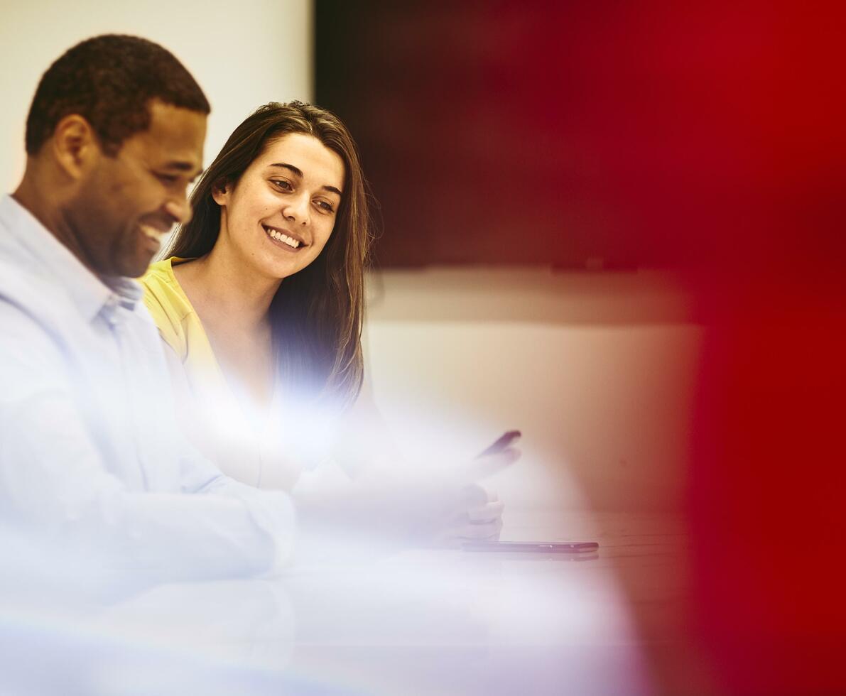 Smiling man and woman in an office