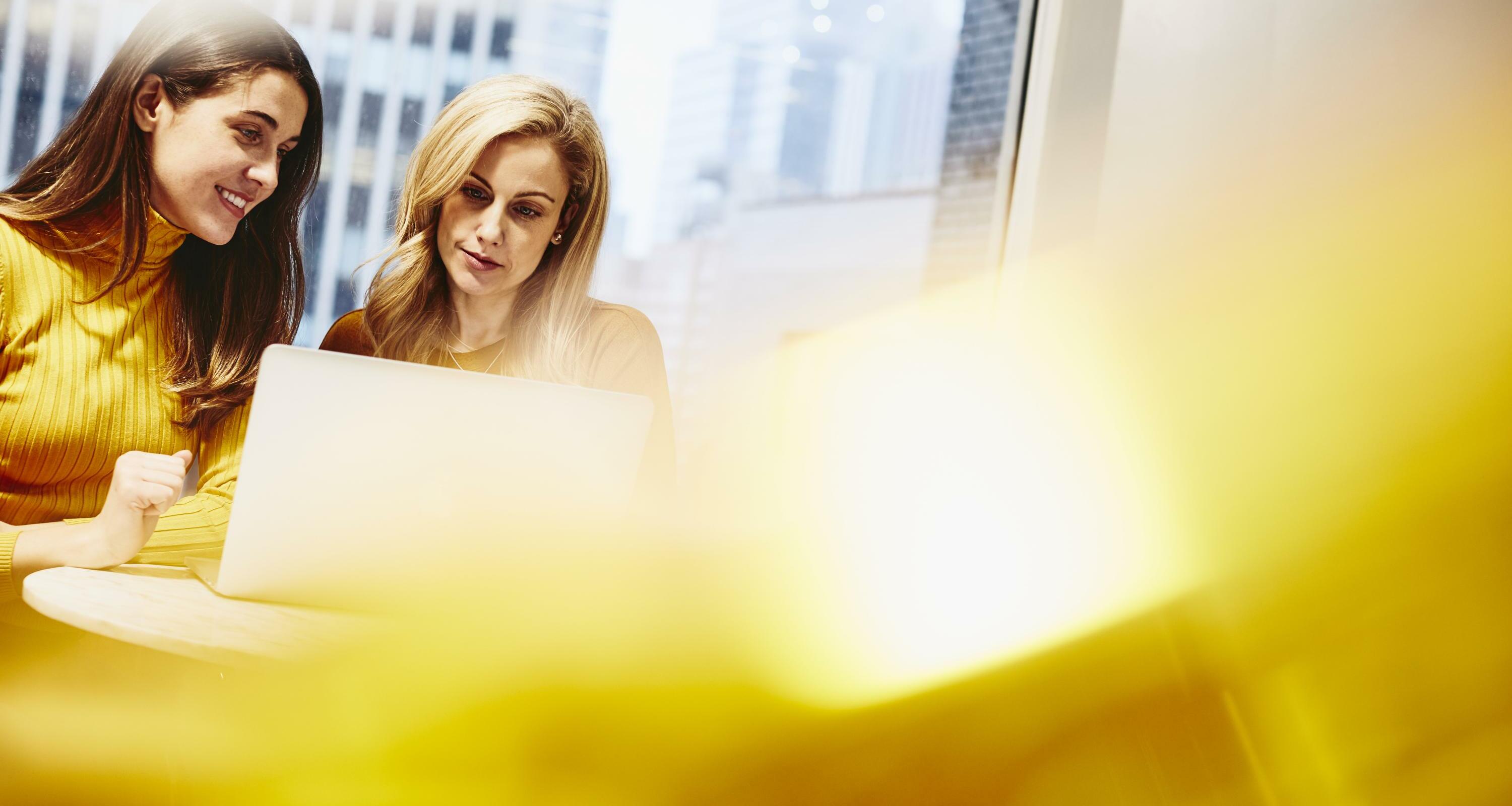 Two women working together