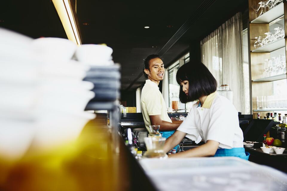 Man and woman bar tending.